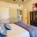 Large well lit bedroom with ceiling fans